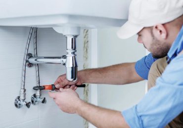 plumbing-1.jpg plumber fixing sink plumbing in California home